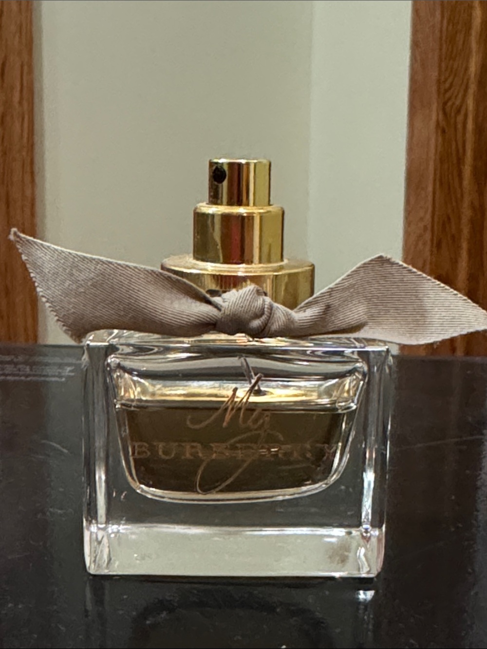 Burberry perfume bottle with gold sprayer and beige bow